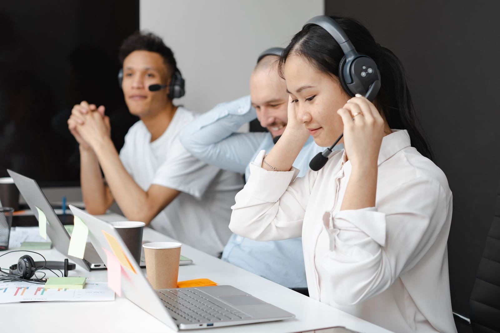 A hospital administrator or call center agent on the phone, connecting a patient or customer with a professional telephone interpreter